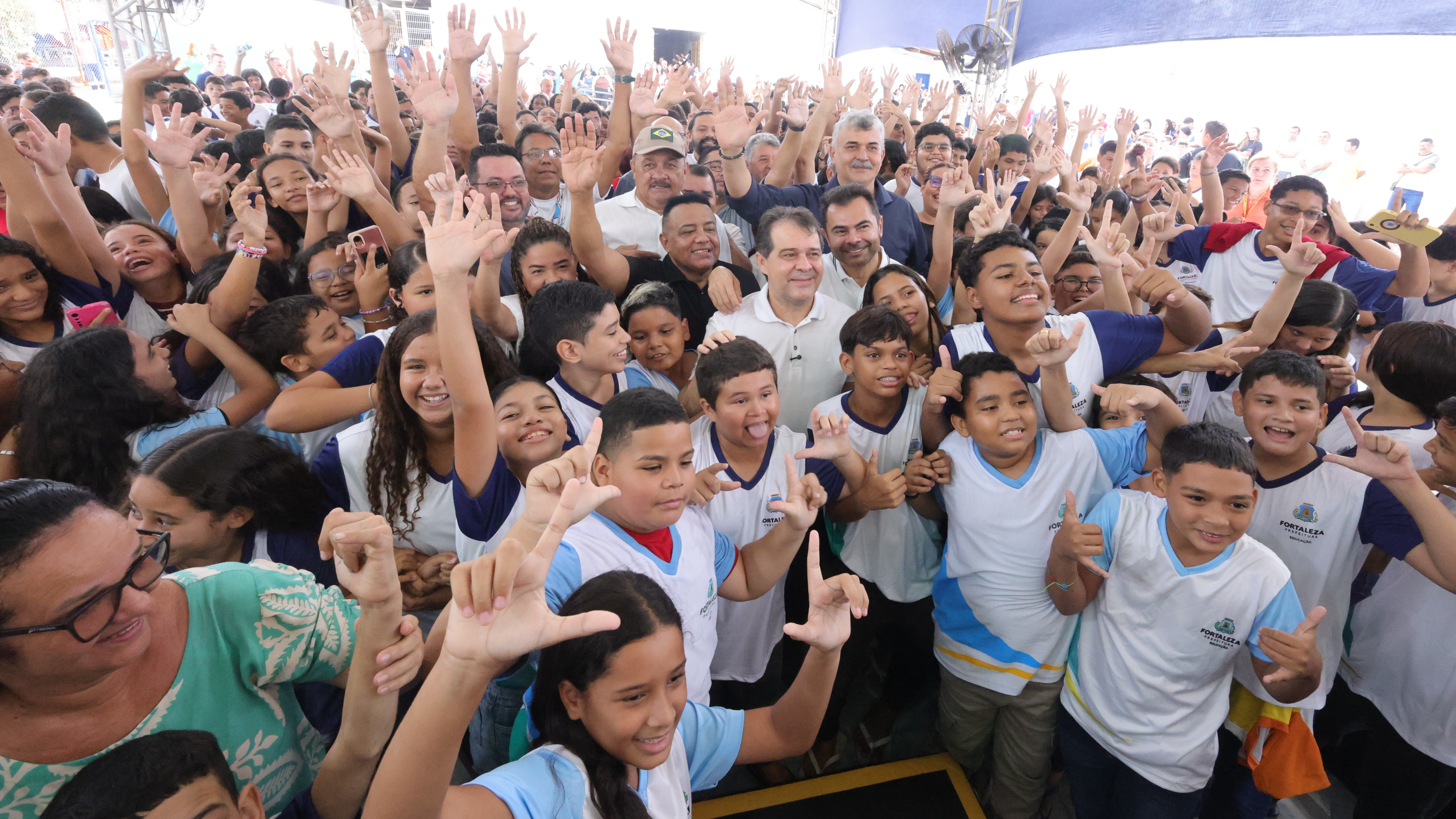grupo de pessoas posa para a foto na quadra da escola